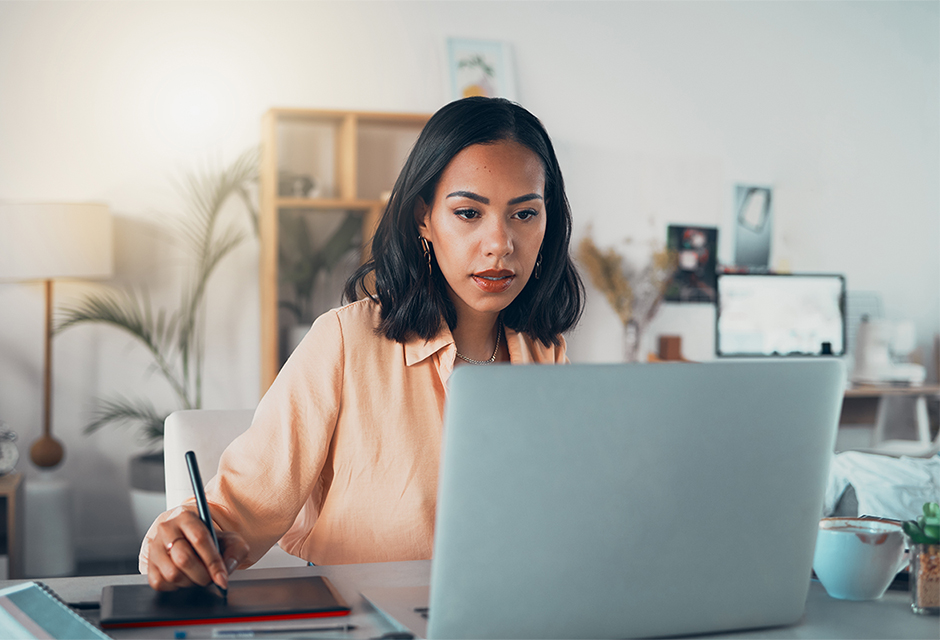 Tax professional reviews proposed pension plan funding rules on a laptop in her office.