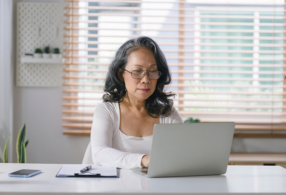 Older taxpayer using a laptop while working through complex aging-client tax issues and family transitions.