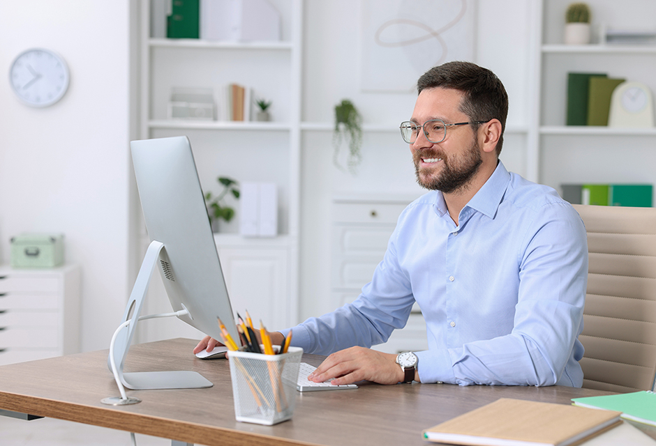 Tax professional reviewing NOL carryforward records and IRS examination guidance on a desktop computer