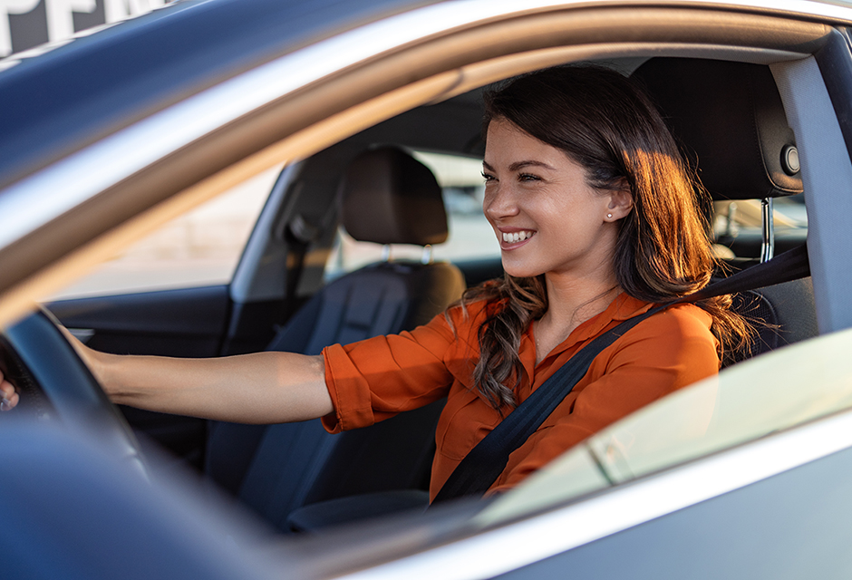 Woman driving a car, illustrating that business driving may be deductible but usually does not qualify for the federal fuel tax credit.