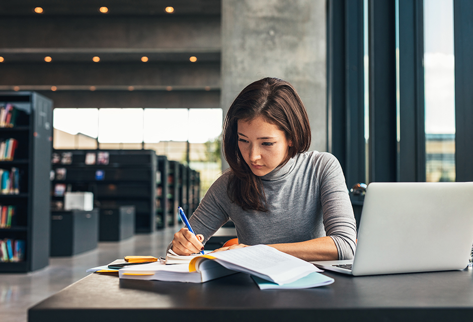 Woman reviewing student loan documents and tax records for student loan forgiveness tax consequences