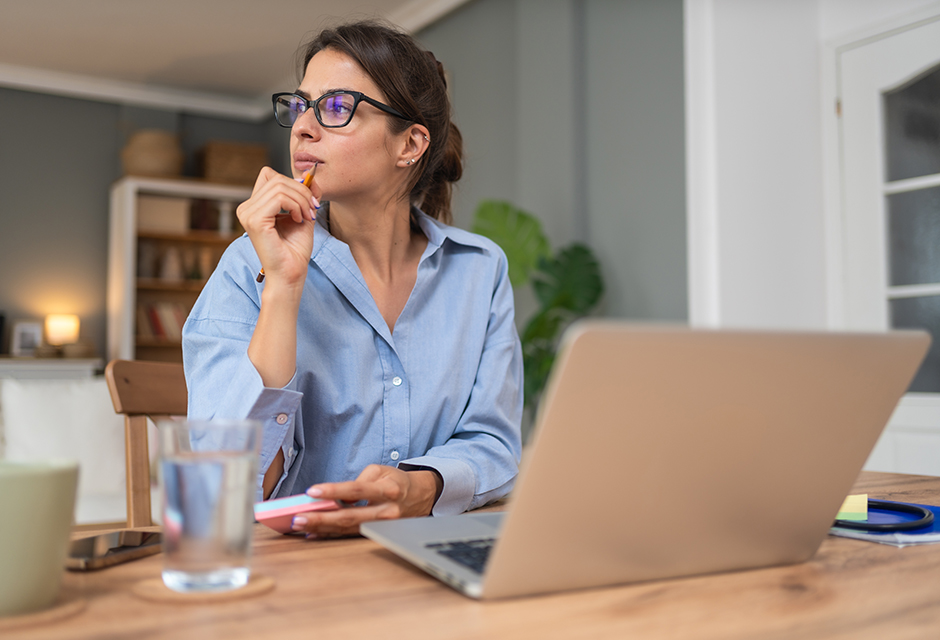 Tax professional at laptop pausing to review how Form 1099-PATR cooperative reporting could change a client’s qualified business income deduction