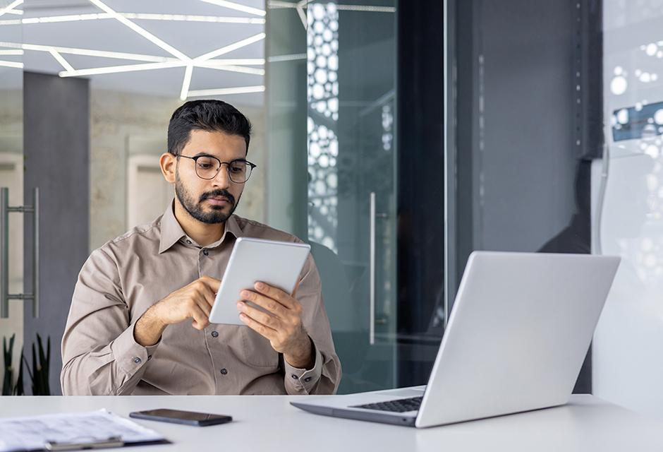 A tax pro reviewing a prior-year return beside a refund/reimbursement notice