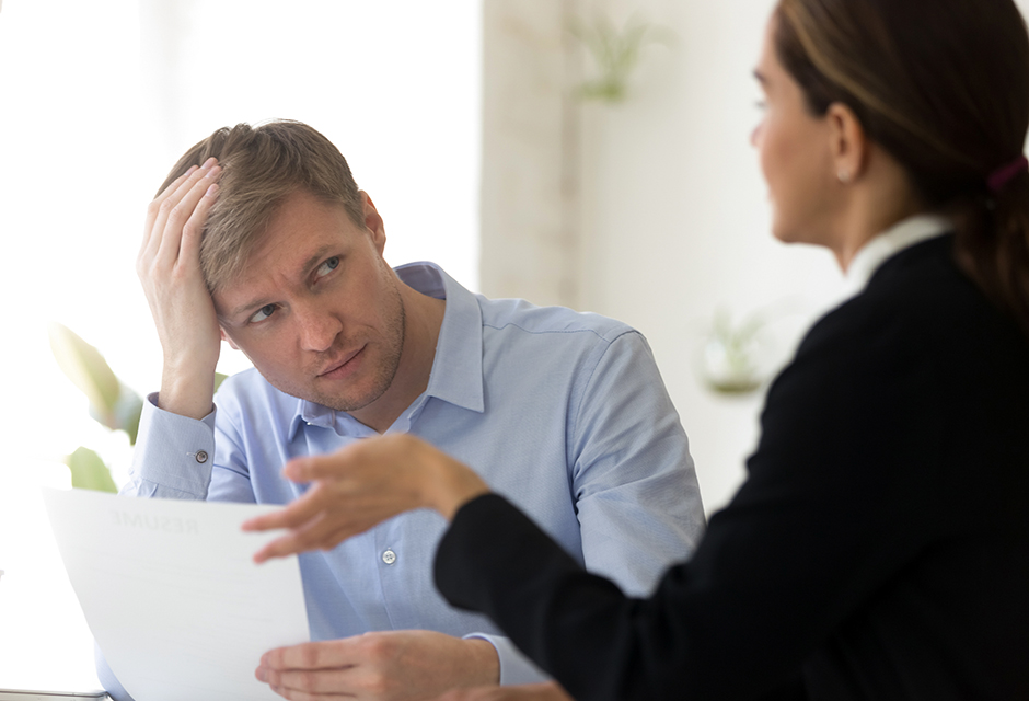 Concerned tax professional reviews documents during a discussion about OPR investigations and Circular 230 compliance.