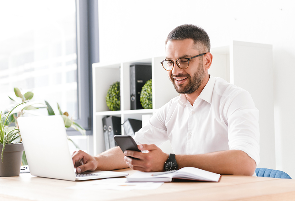 Tax professional reviewing paperwork and financial records at a desk while determining the tax treatment of class action settlement payments.