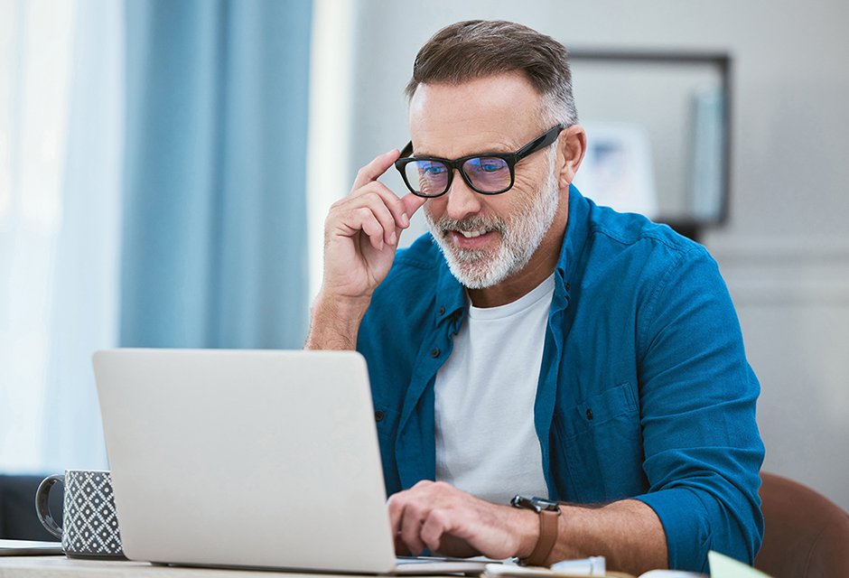 Man in glasses reviewing proposed TAS Act changes on a laptop.