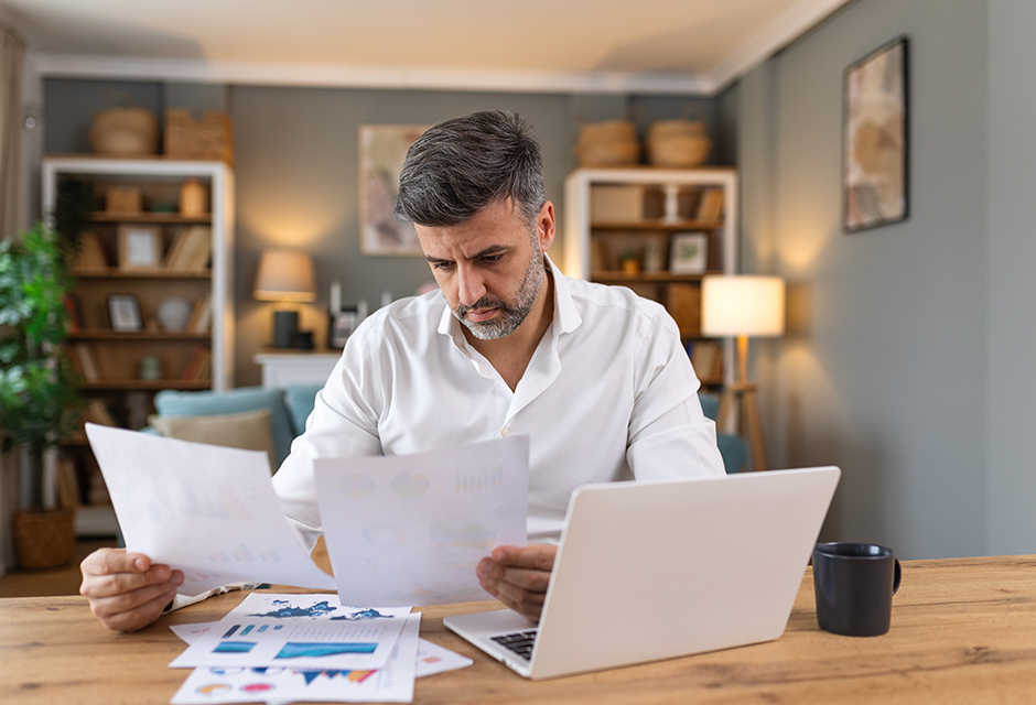 Tax preparer reviewing Form 2439 and brokerage documents to verify undistributed long-term capital gains claims and avoid abusive IRS issues