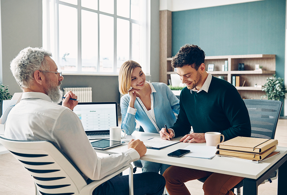 Tax professional meeting with two business owners to discuss the tax effects of adding a member to a single-member LLC.