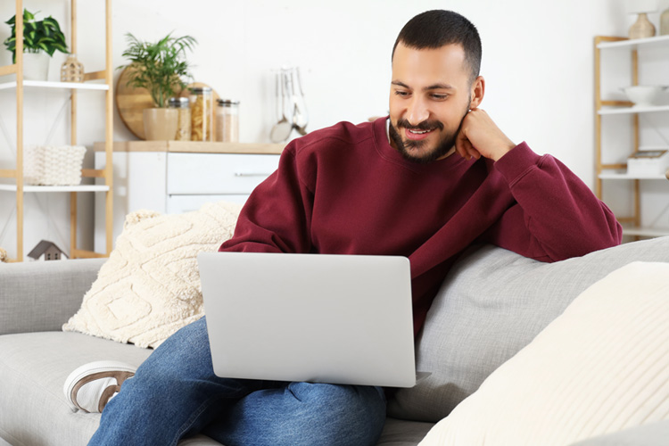 Tax professional reading industry insights on laptop from home