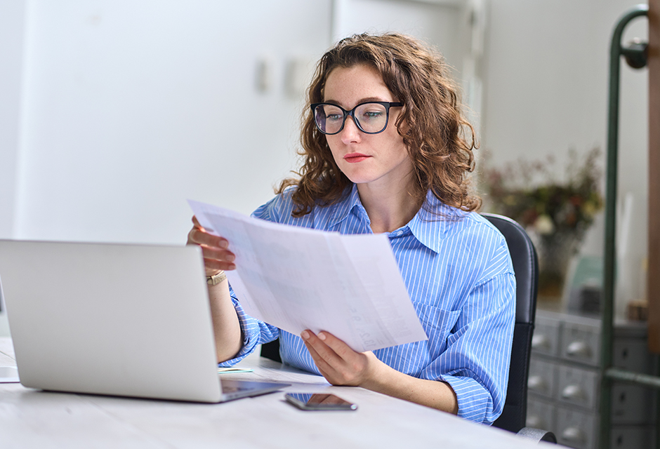 Tax professional reviews dependent care paperwork before completing Form 2441 for child and dependent care tax benefits