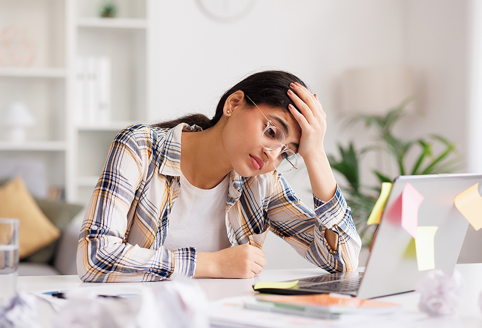 Stressed tax professional reviews paperwork while navigating short-term rental audit rules and documentation issues.