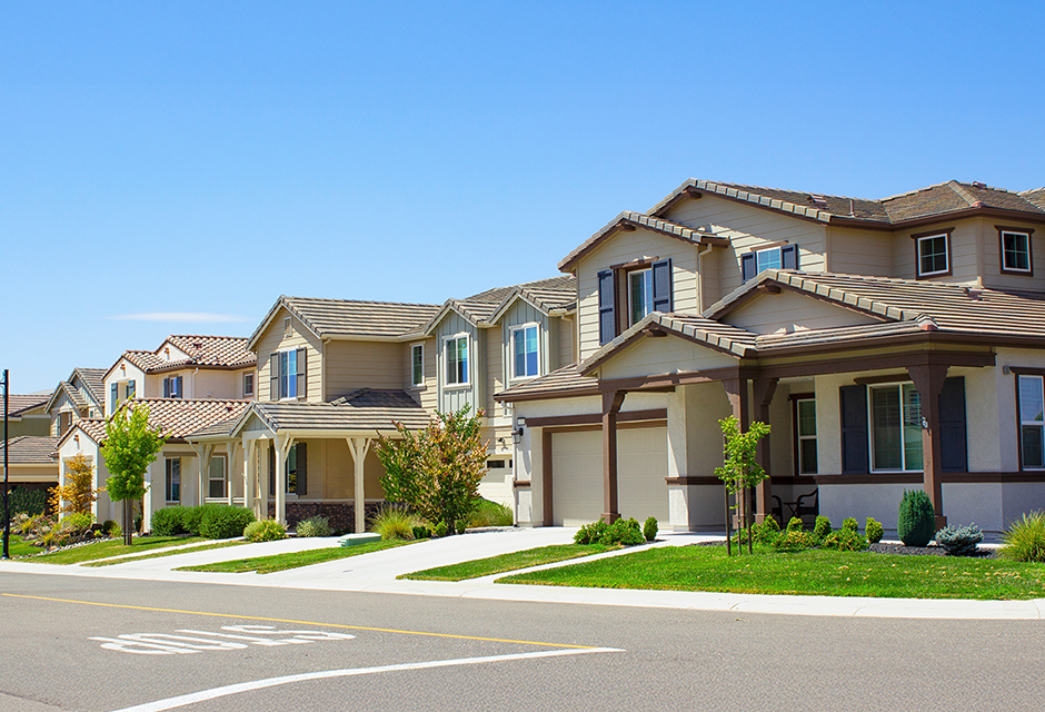 Row of suburban homes illustrating rental property tax considerations for owners and tax professionals.