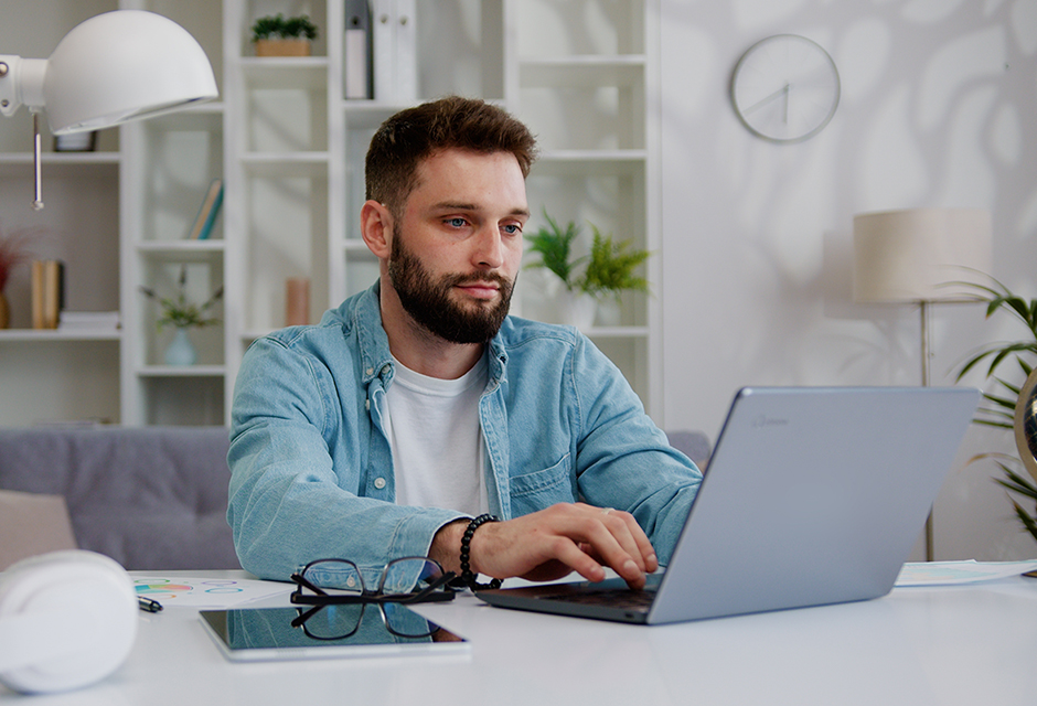 Man reviewing information on a laptop at home, illustrating careful Schedule K-1 reporting for estate and trust beneficiaries.