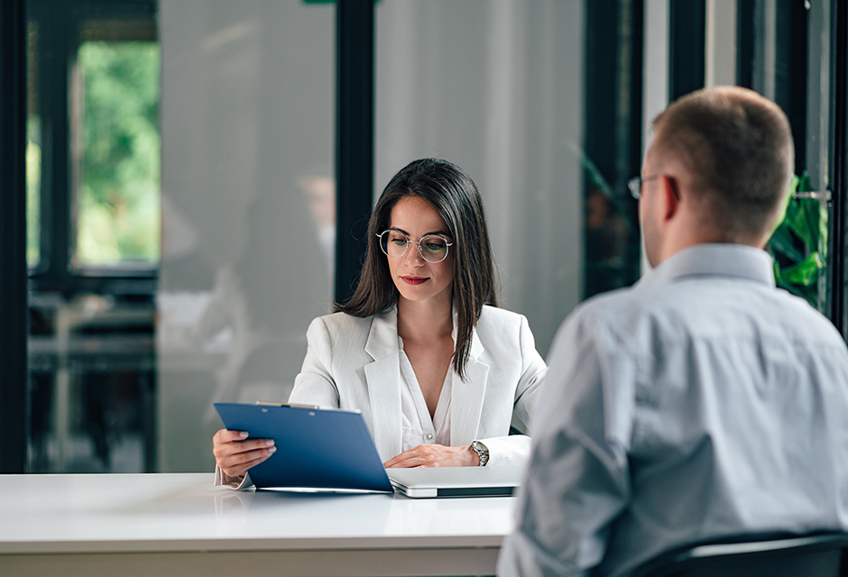 A tax professional reviews documents with a client while discussing whether to request an IRS private letter ruling.