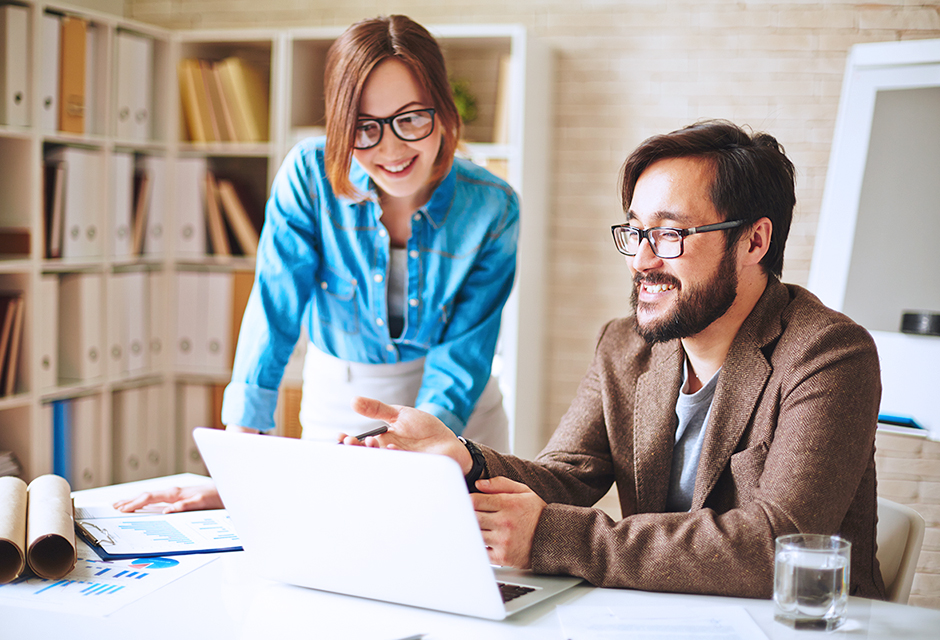Two tax professionals review documents together while researching how state conformity can change the treatment of federal tax provisions.