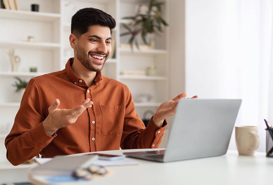 Tax professional smiling while reviewing IRS Automatic Exemption from Penalty guidance on a laptop