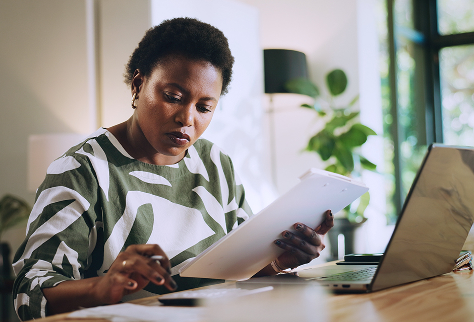 Woman reviewing financial documents to determine how gifts, inheritances and other payments received after death are taxed