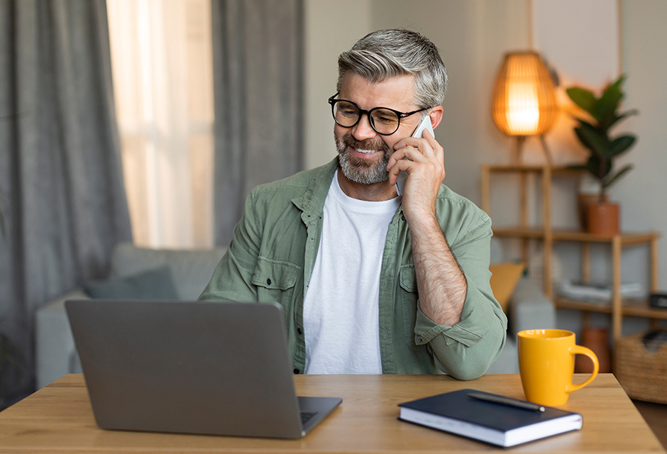Man speaking by phone at a desk, representing a client conversation about cost segregation planning.