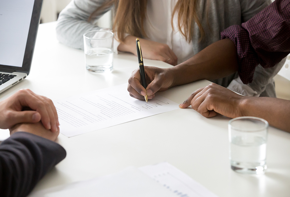 Tax professional reviews IRS due diligence documentation with a client to support accurate tax return preparation and reduce preparer penalty risk