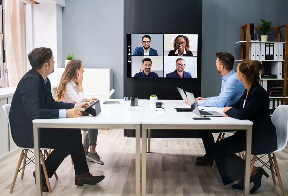 Tax professionals review expanded executive compensation rules for tax-exempt organizations during a hybrid compliance meeting