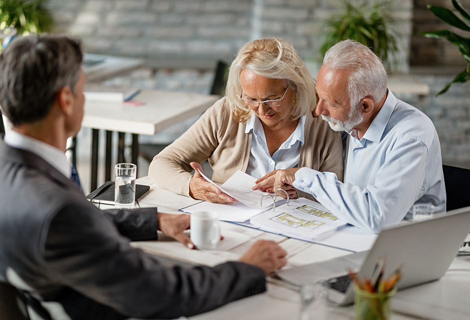 Tax professional guides older clients through Roth conversion planning, reviewing tax impact, IRA basis and retirement income strategy