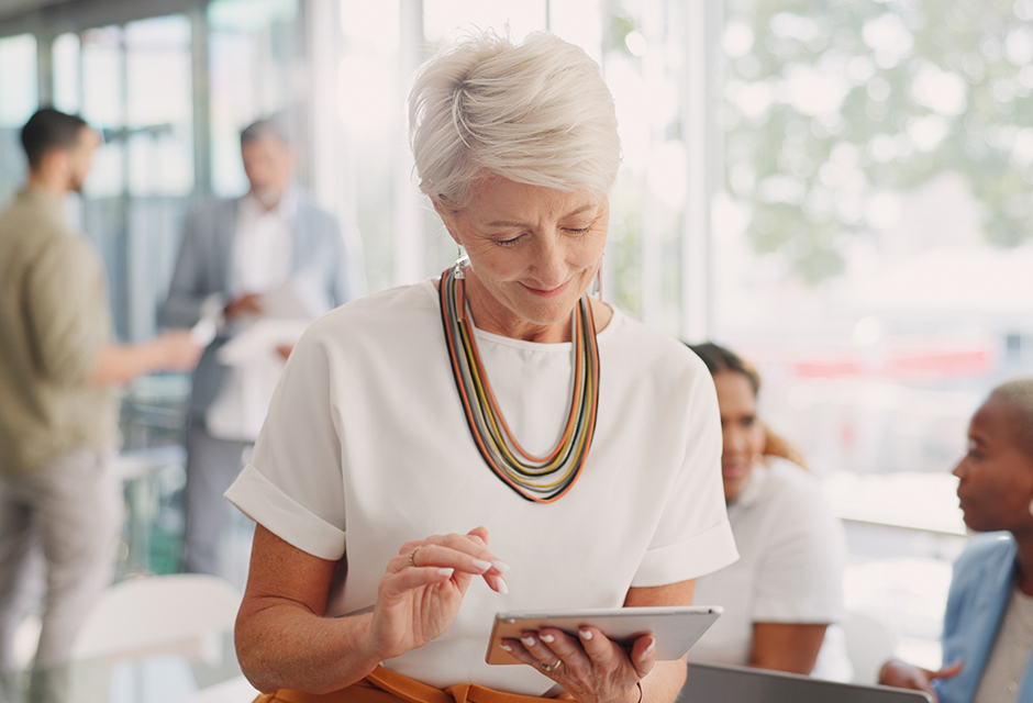 Tax professional reviewing IRS information on a tablet as the TAS Act advances proposals affecting preparer standards and online services.