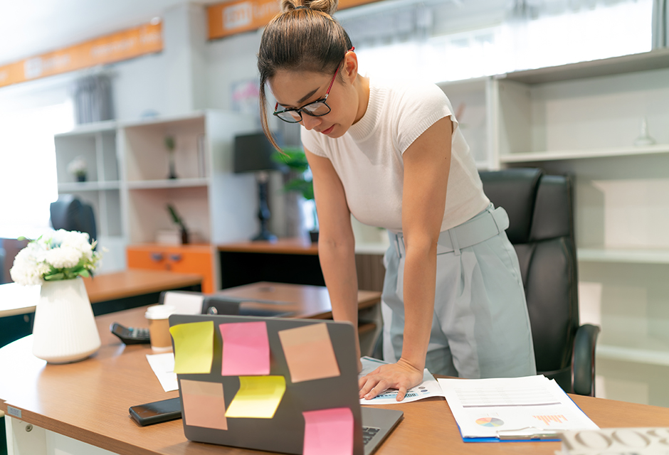 Tax professional reviewing documents and evaluating office workflows to identify where technology can improve efficiency in a tax practice.