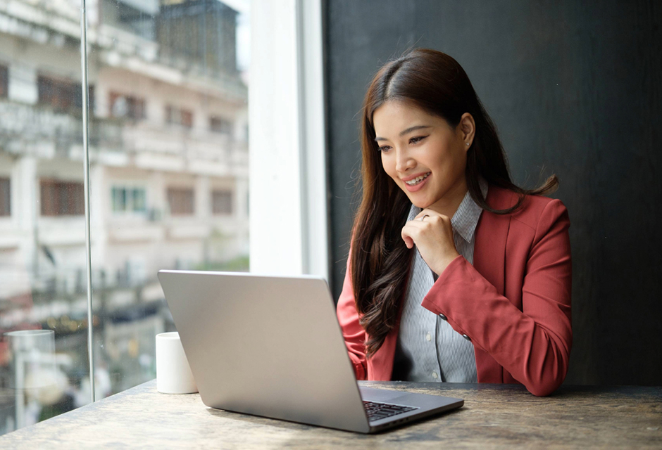 Woman working on a laptop, illustrating the shift from tax compliance work to strategic advisory.