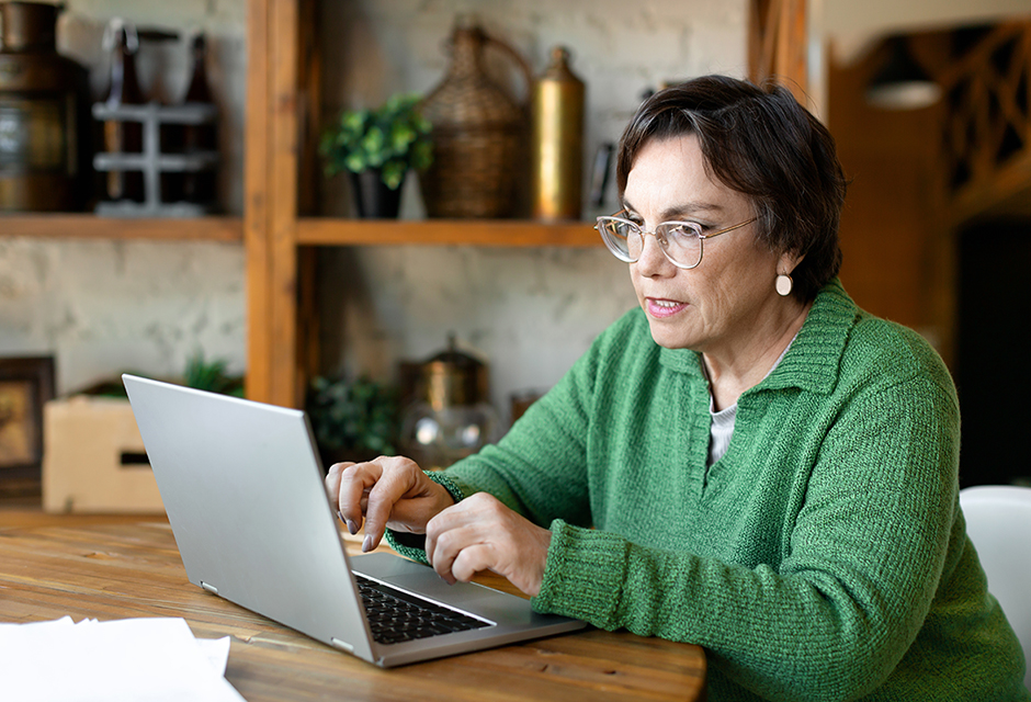 Woman reviewing a return on a laptop, reflecting the careful follow-up needed after an e-file rejection.