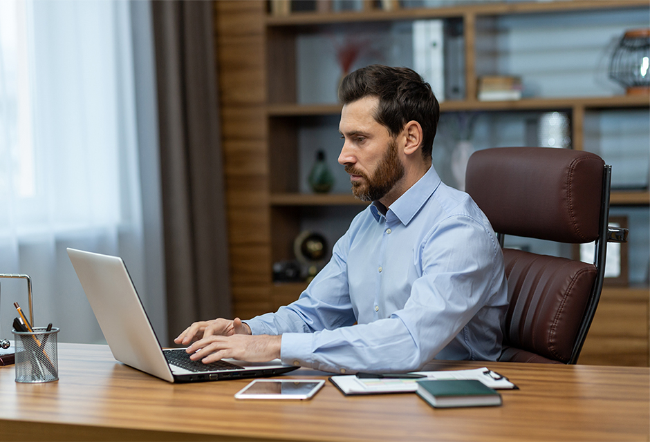 Tax professional reviewing succession planning details at his office computer