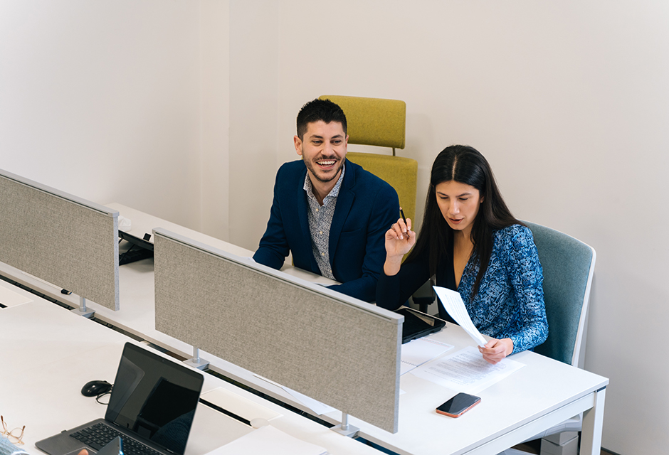 Two tax firm staff members reviewing IRS e-file compliance, ERO responsibilities and EFIN access before filing season