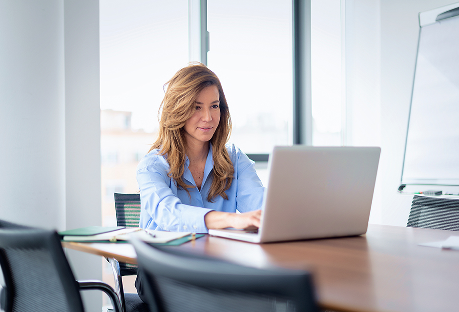 A tax professional reviews disaster-related casualty loss deductions on a laptop, highlighting tax relief available to affected homeowners.