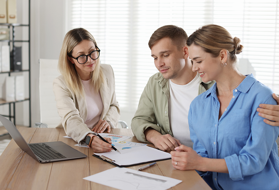 Tax professional reviewing trust planning documents with a couple as they consider tax consequences and long-term tradeoffs