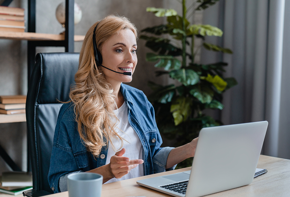 Tax professional wearing a headset uses a laptop to contact the IRS and manage client account issues