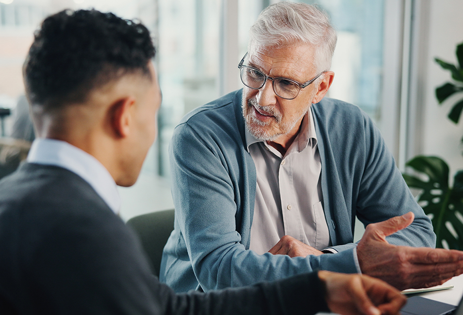 Tax professional reviewing a minister’s Form W-2 and housing allowance with a client