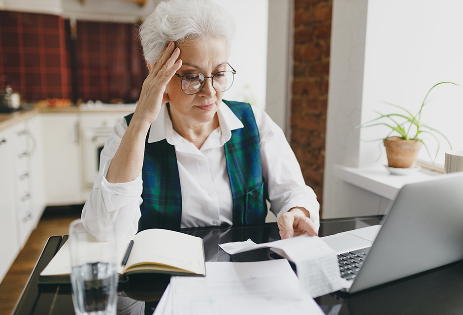 Tax professional reviewing trust taxation documents and Form 1041 preparation materials at a laptop