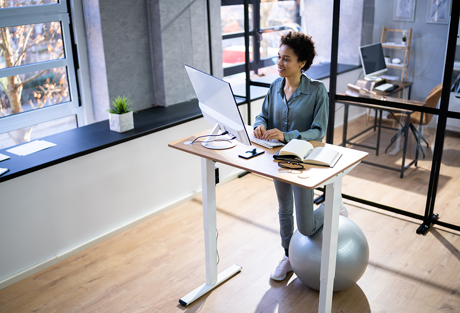 Tax professional working at an adjustable desk while building a firm-specific written information security plan.