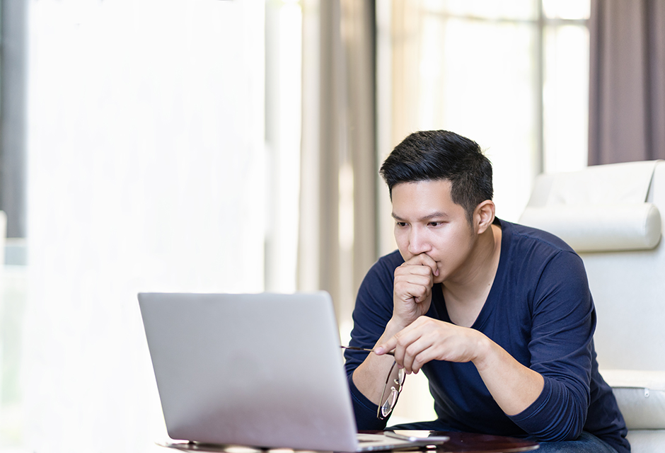 Concerned tax professional reviewing IRS penalty and interest relief options on a laptop