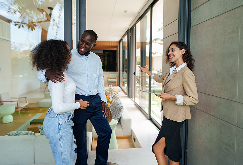 Real estate professional discusses an investment property with clients for a Section 1031 like-kind exchange.
