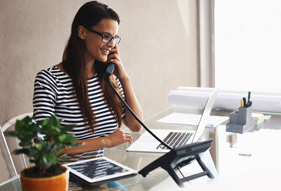 Tax professional reviewing blueprints and calculations for long-term contract look-back interest reporting