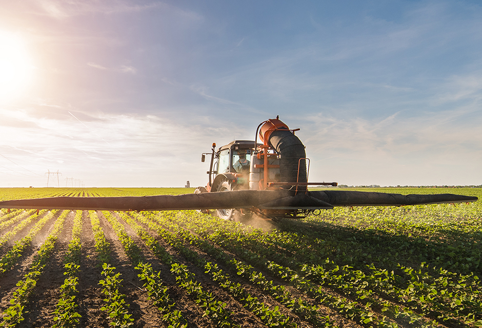 Farm equipment in crop field representing taxable USDA tariff-related farm aid planning for tax professionals
