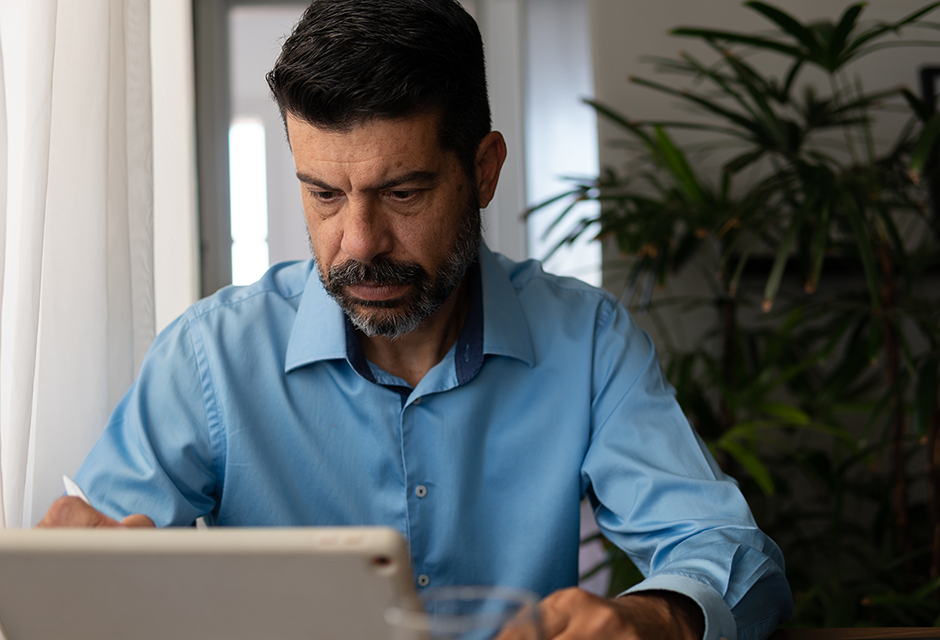 Tax professional reviewing S corporation stock basis records on a laptop to help prevent costly reporting errors