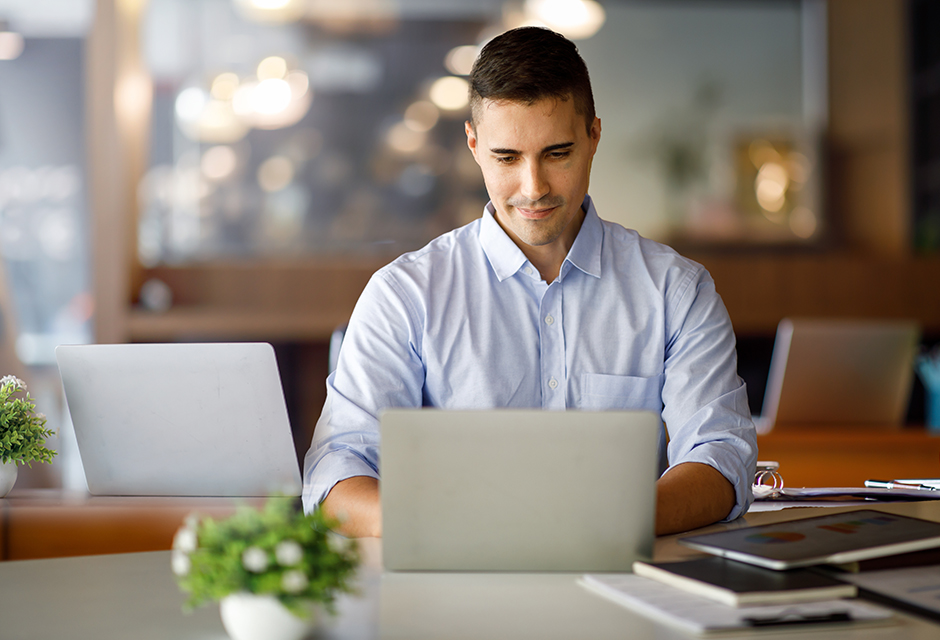 Man working on a laptop in a bright workspace, illustrating advance planning for IRS representation with a durable power of attorney.