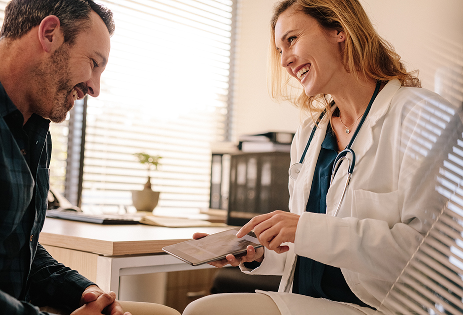 Doctor reviewing medical paperwork with patient for 2027 HSA limits and health savings account planning