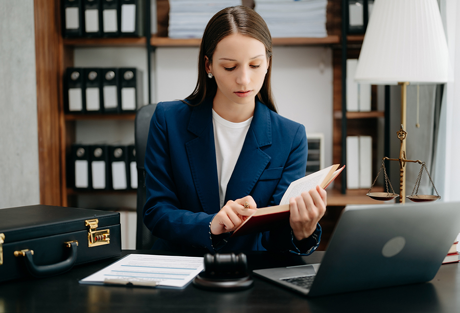 Tax professional reviewing Tax Court research materials with legal documents, tablet and gavel to evaluate precedential authority