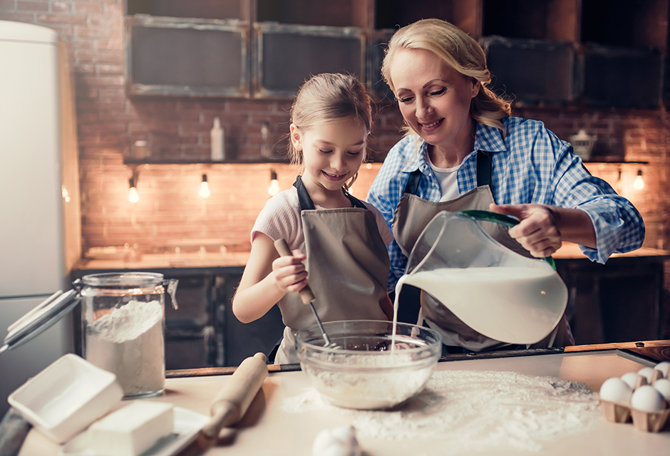 Parent and older child baking together at home, representing family tax situations involving kiddie tax and child unearned income