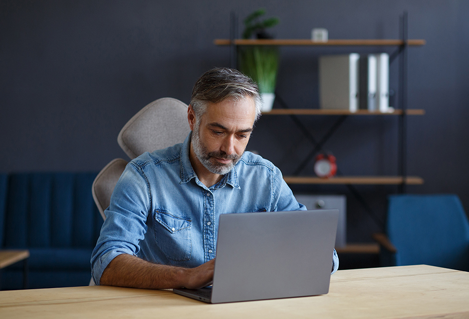 Man reviewing the 2026 auto loan interest deduction phaseout calculation on a laptop