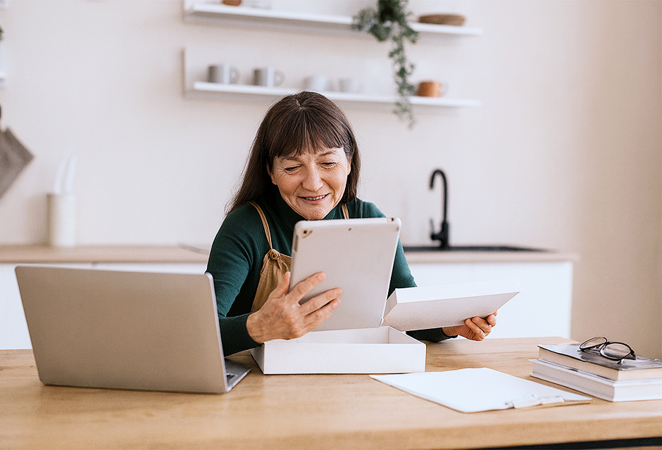 Small business owner reviewing year end financials and tax planning options at a desk with documents and a laptop
