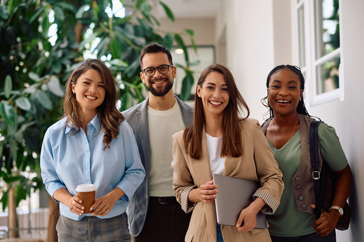 Four happy professionals fostering community and supporting tax careers as described in NATP mission.