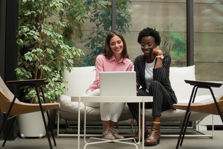 Two professionals reviewing tax resources on a computer with NATP mission statement.